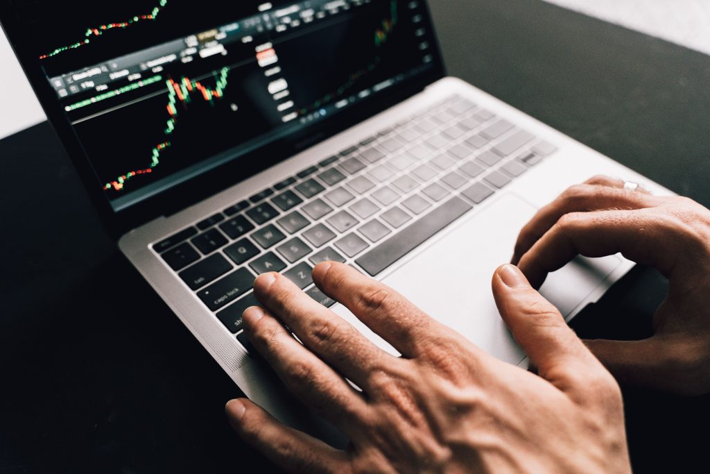 hands typing resume on laptop screen