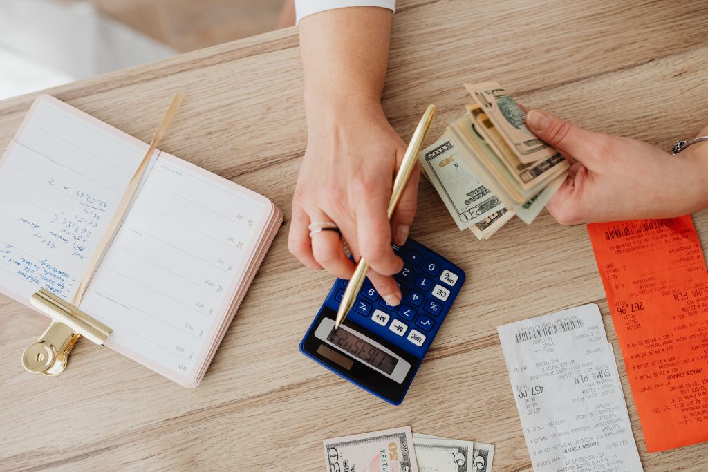 hands using calculator and financial papers
