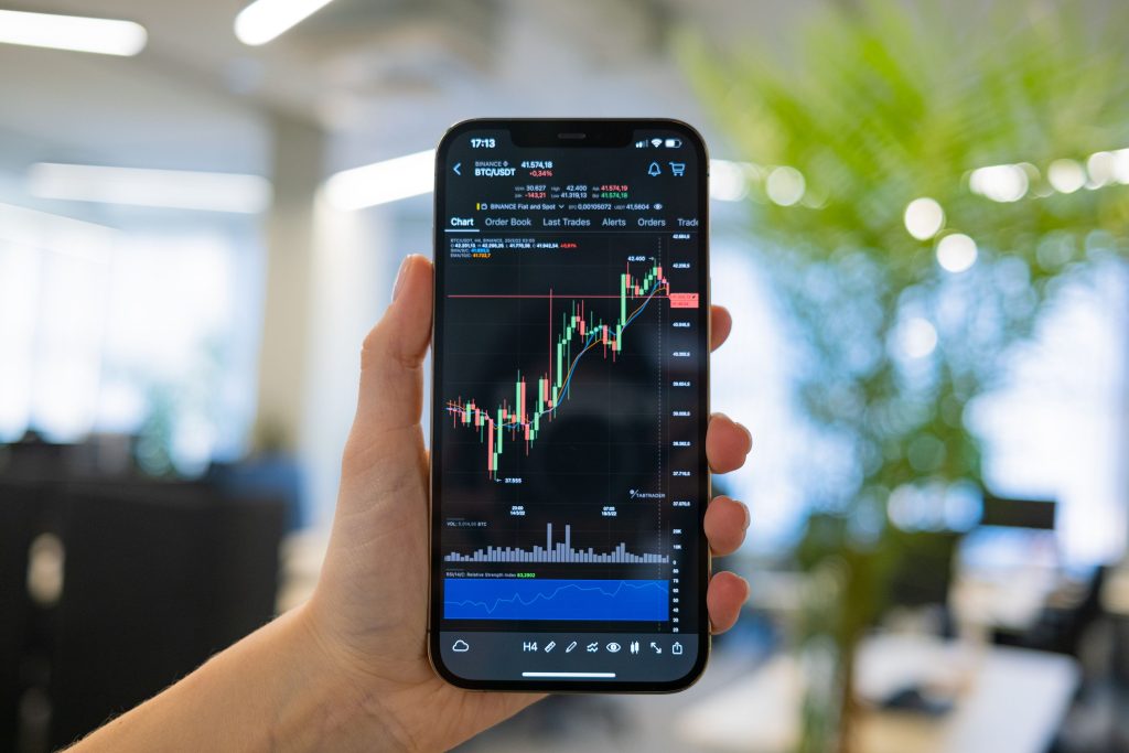 holding smartphone stock market chart